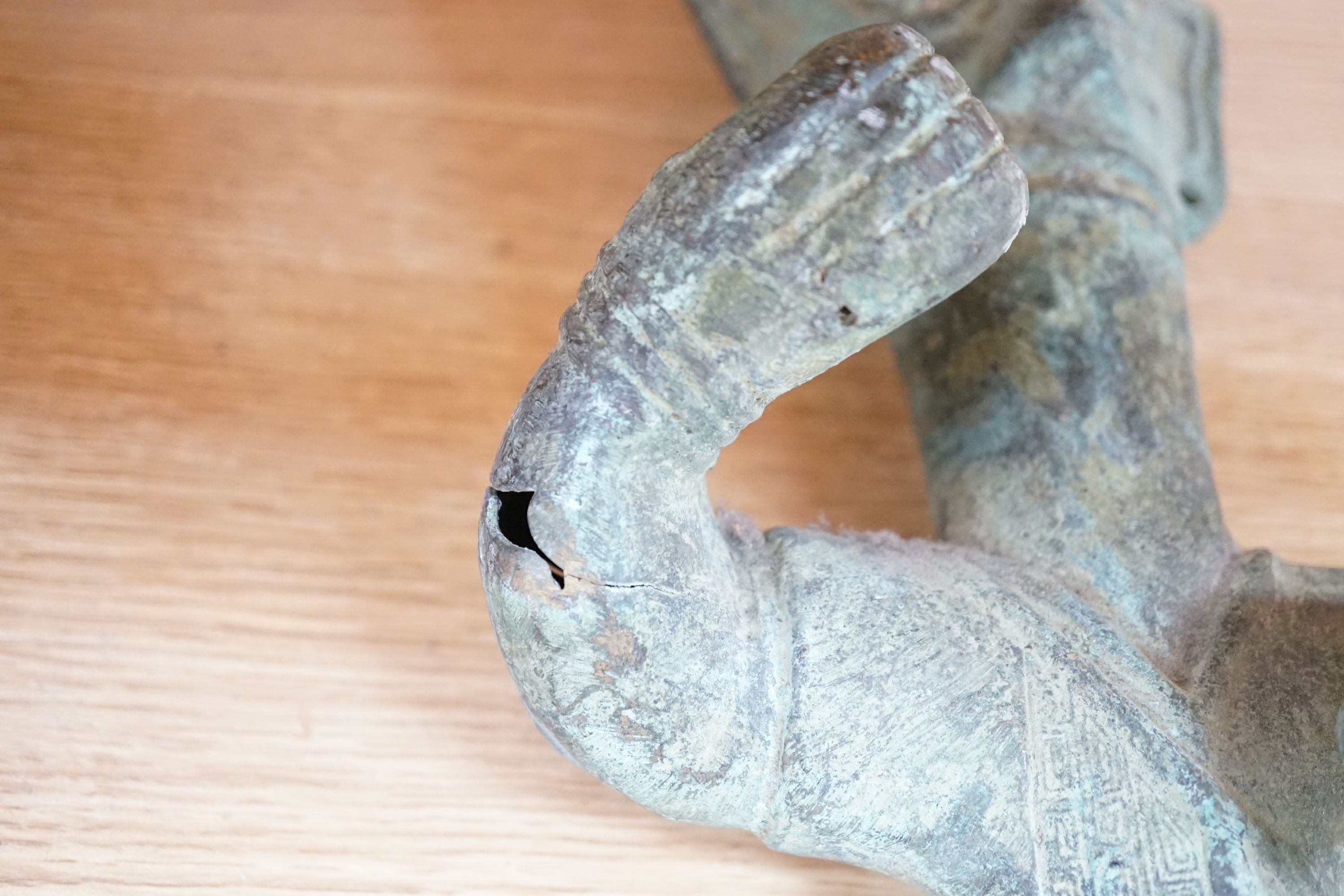 A large, archaic tic bronze figure, 76cm, and a bronze bell on chain